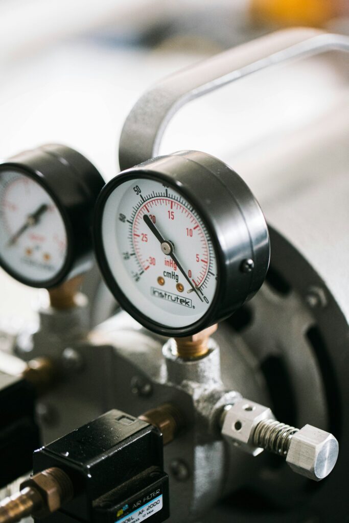 Two pressure gauges fitted to industrial equipment
